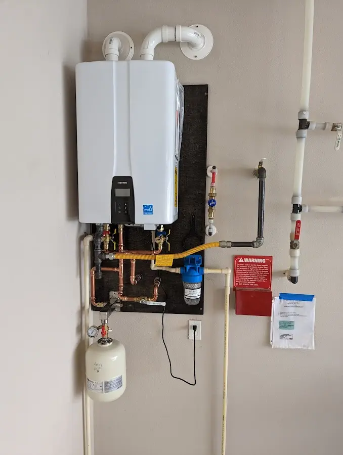 Professional plumber installing copper piping in a Wood River home